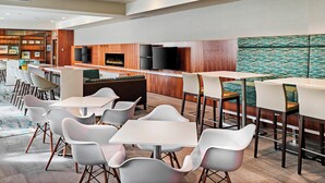 A modern hotel lobby with a bar area, seating arrangements, and a fireplace. - Delta Hotels by Marriott Dartmouth (Dartmouth)