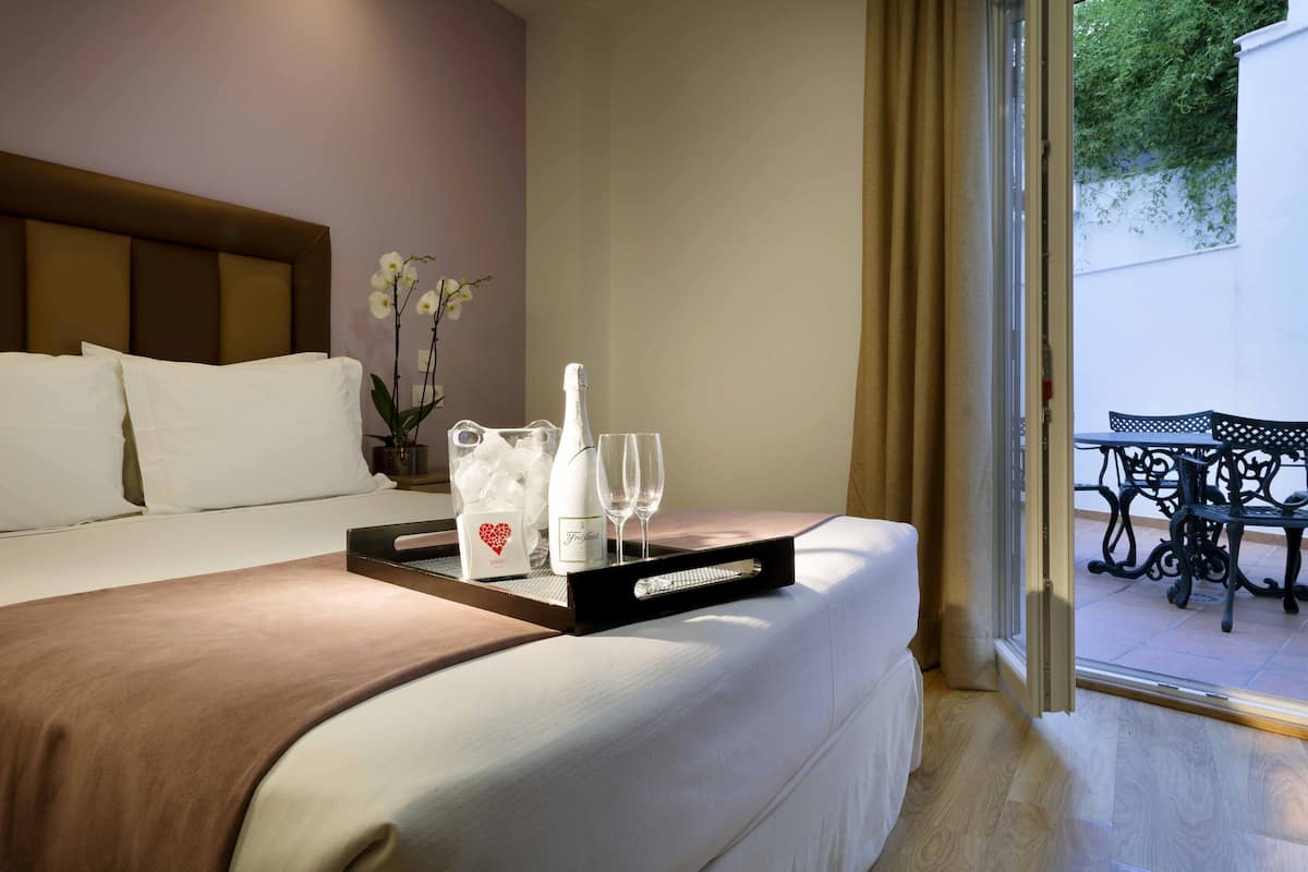 Double room with patio | Minibar, in-room safe, soundproofing, iron/ironing board
