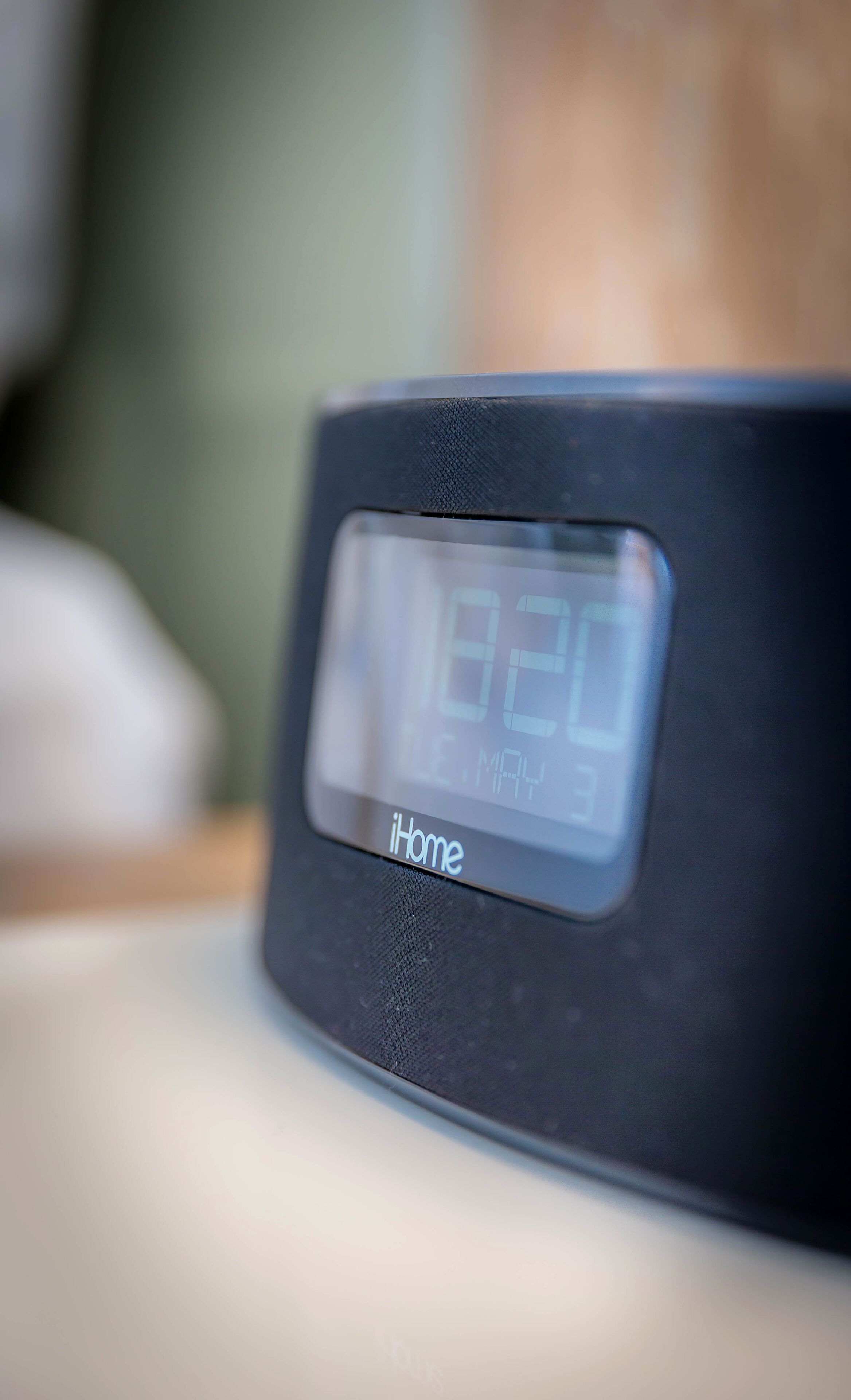 A black iHome digital clock displaying the time as 12:20.