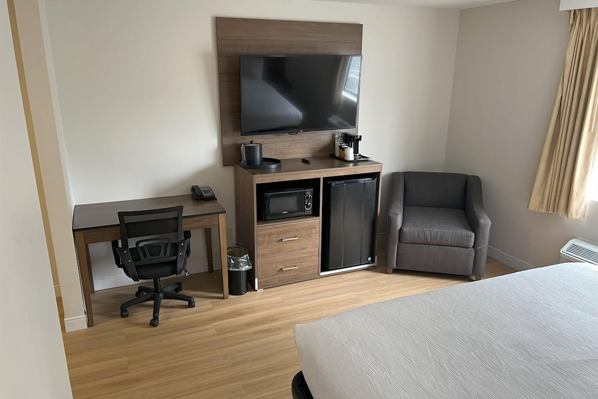 Desk, laptop workspace, blackout drapes, iron/ironing board