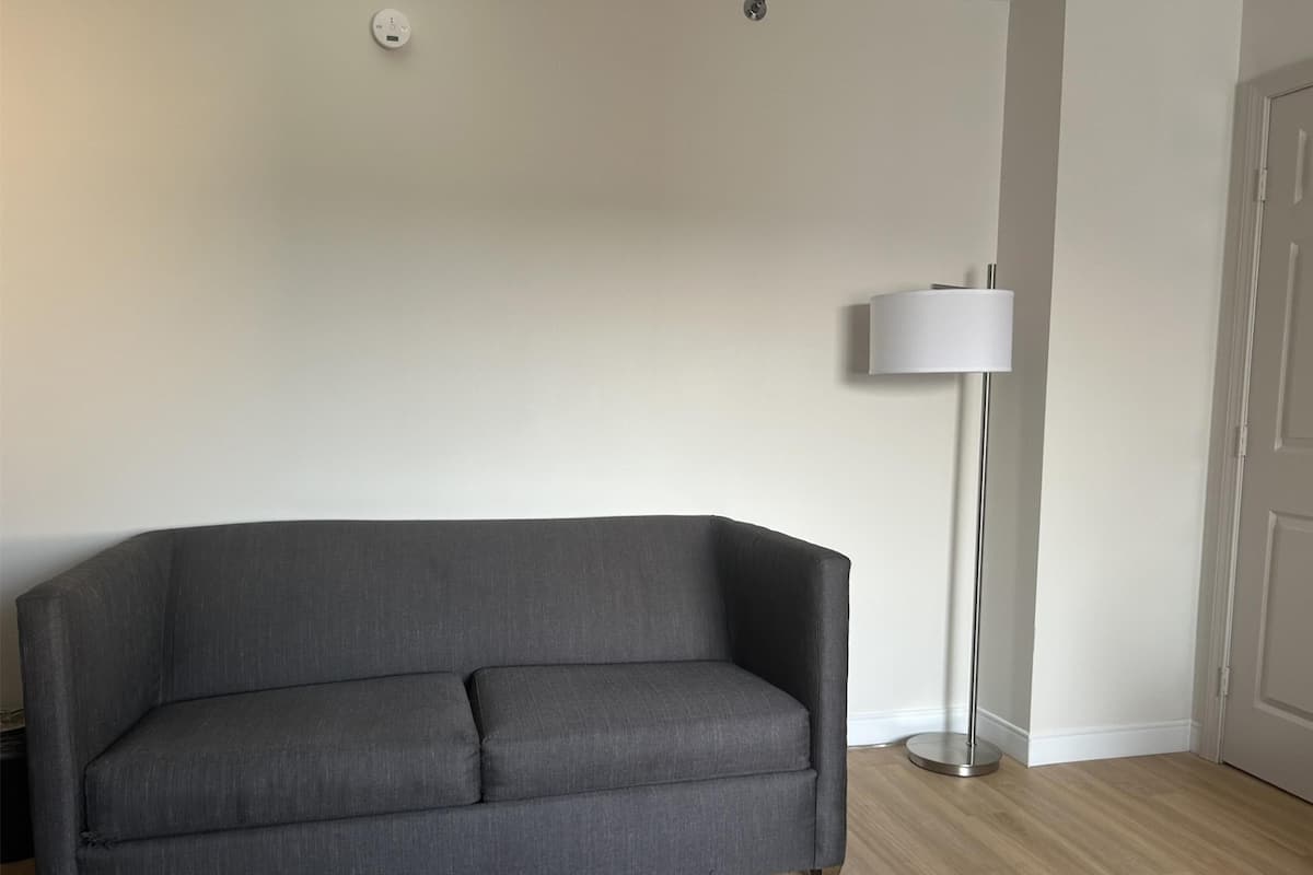 Desk, laptop workspace, blackout drapes, iron/ironing board
