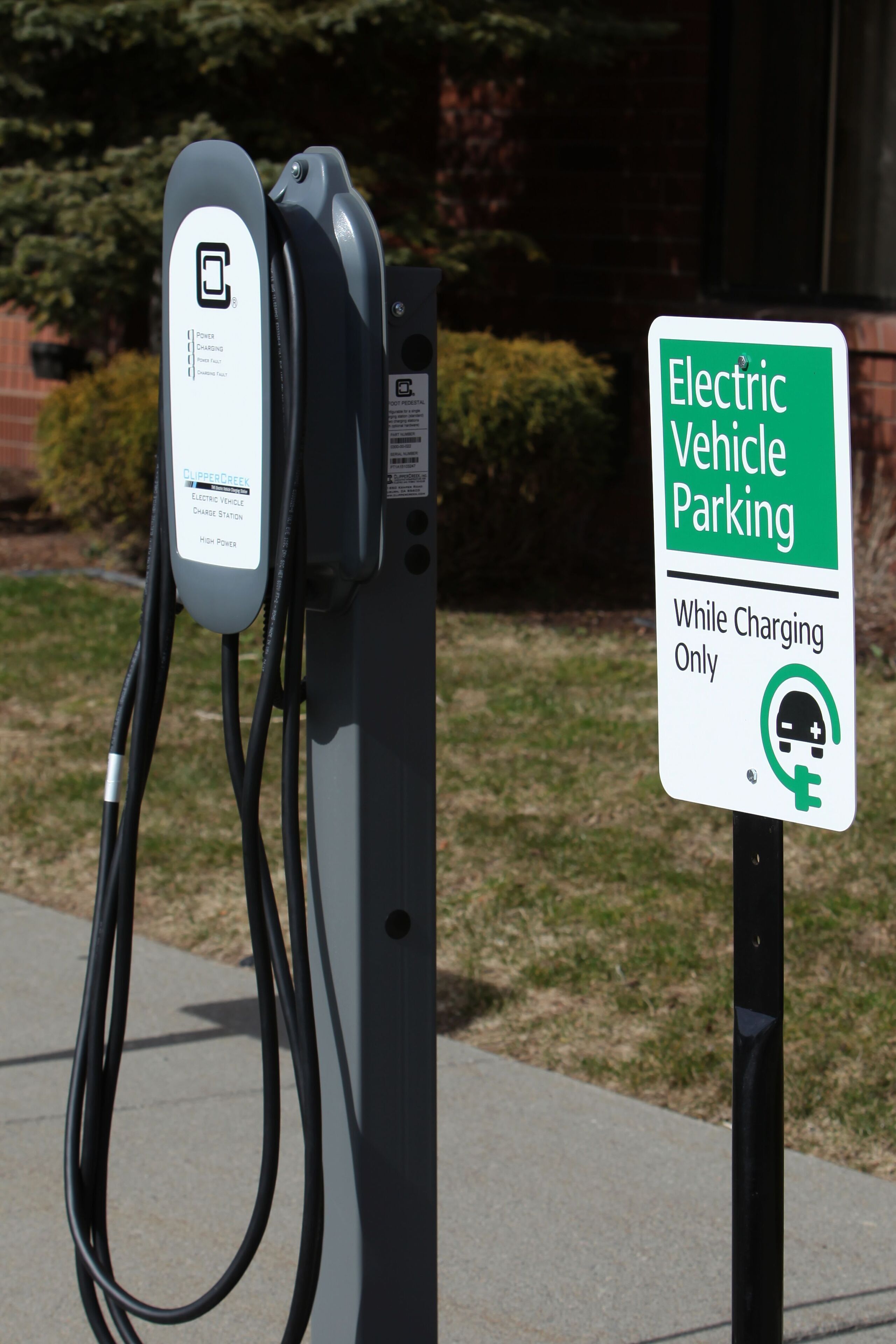 An electric vehicle charging station with a sign indicating it is for electric vehicles and charging only.
