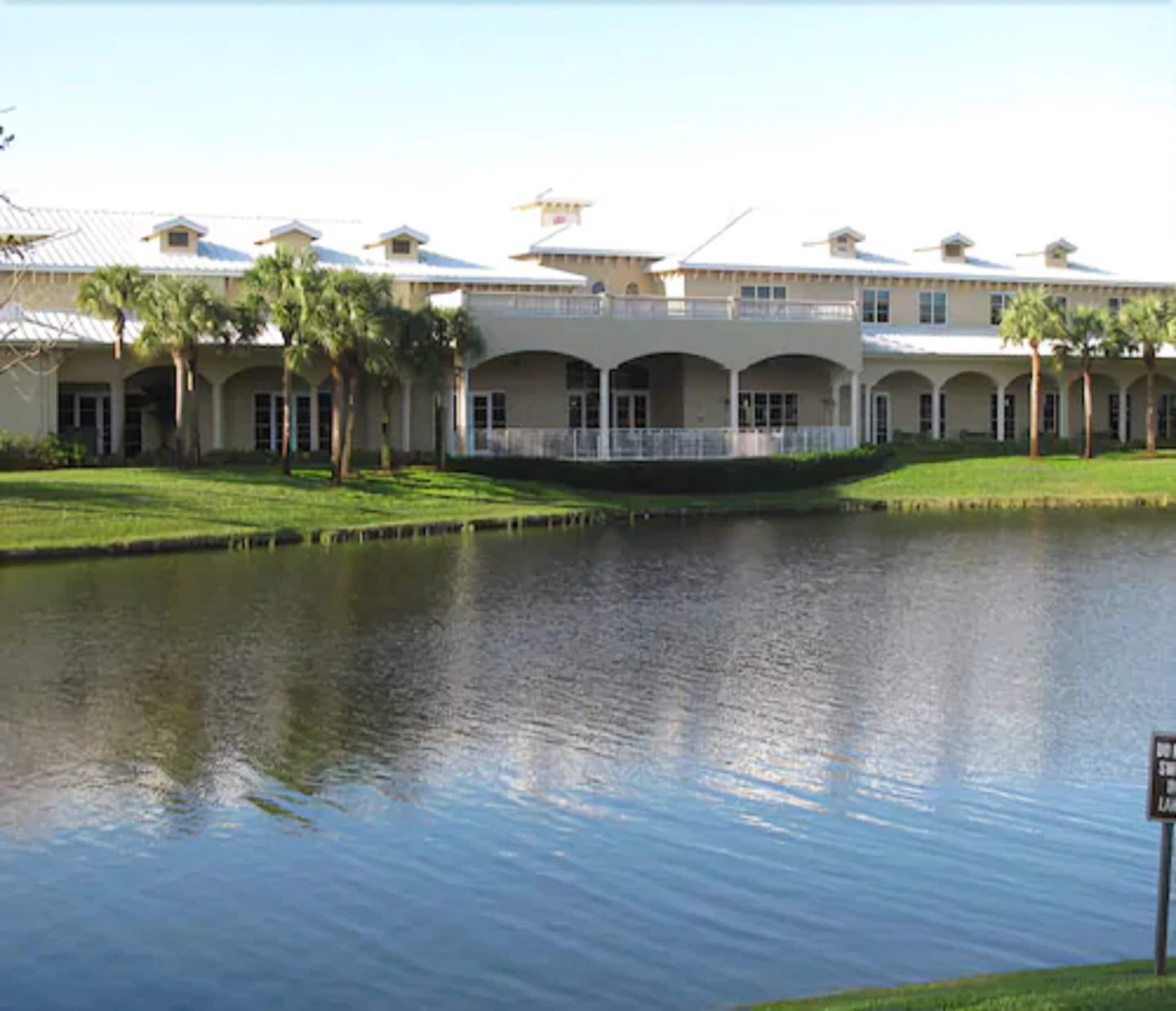 A large building with a water feature in front.