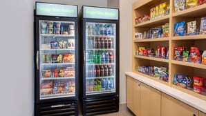 Two refrigerated display cases labeled "Bright Side Market" with various food and drink items. - La Quinta Inn & Suites by Wyndham Madera (Madera)