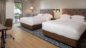 A hotel room with two beds, a desk, and a view of the outdoors. - Four Points by Sheraton Bakersfield (Bakersfield)