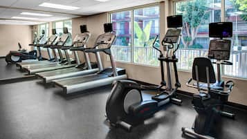 A gym with treadmills, an elliptical, and a stationary bike.