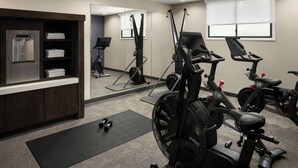 A gym with exercise equipment, a water dispenser, and a mirror. - Residence Inn by Marriott Palo Alto Mountain View (Mountain View)