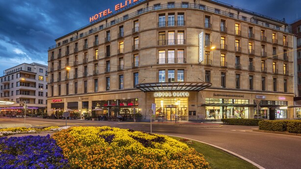 A large, historic hotel building with a prominent "HOTEL ELITE" sign, featuring multiple floors and a classic architectural style. - GLANDON Rooms Elite (Biel)