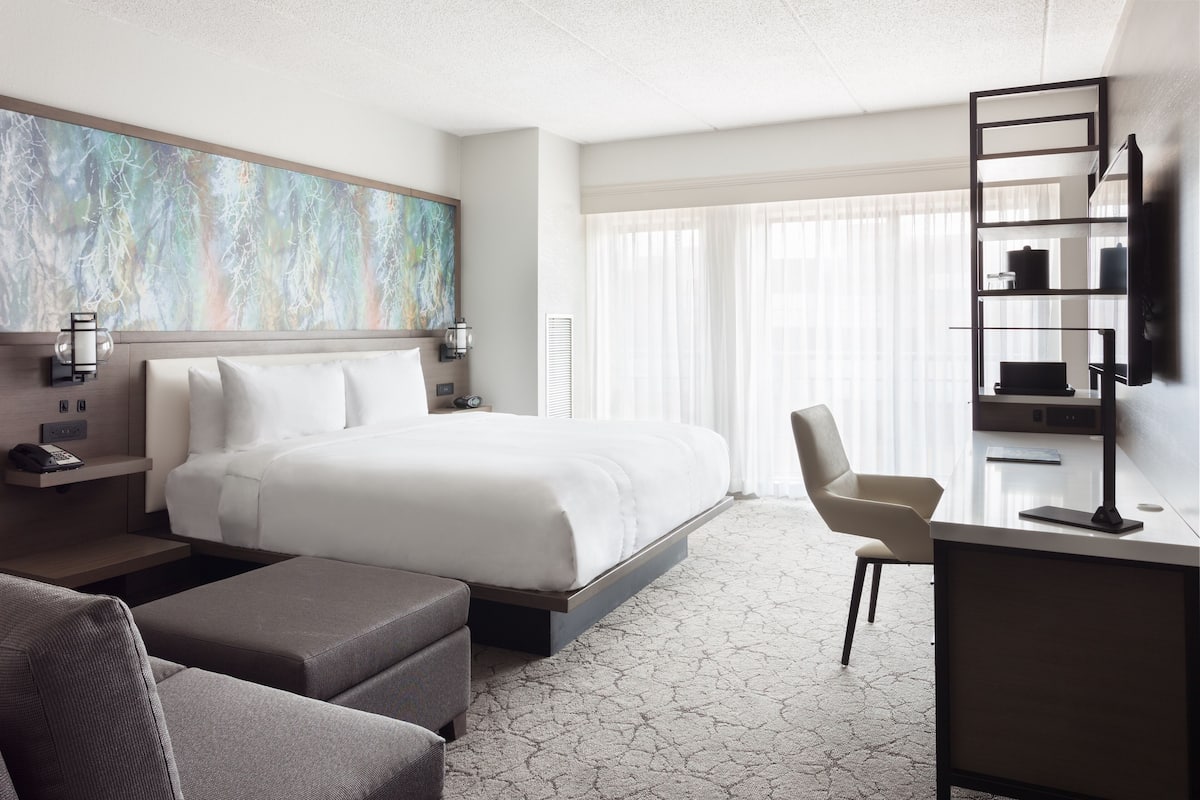 Premium bedding, desk, laptop workspace, blackout drapes