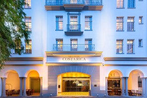 Classic entrance with arched doorway and decorative balconies.