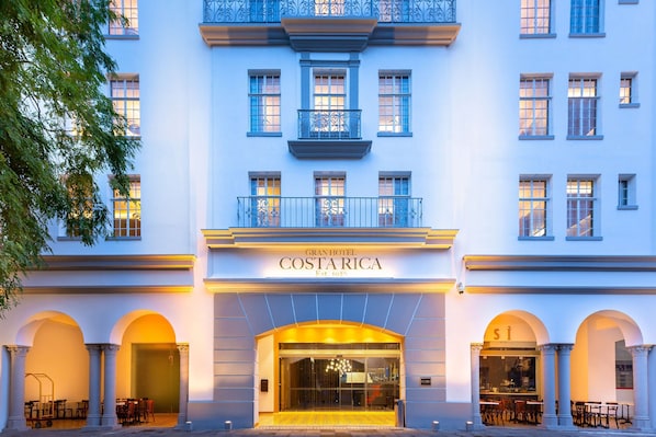 The Gran Hotel Costa Rica facade with a central entrance, balconies, and arched windows.