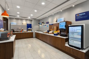 A modern breakfast area with a digital menu display, wooden cabinets, and a sign indicating 'Express Start Breakfast'.