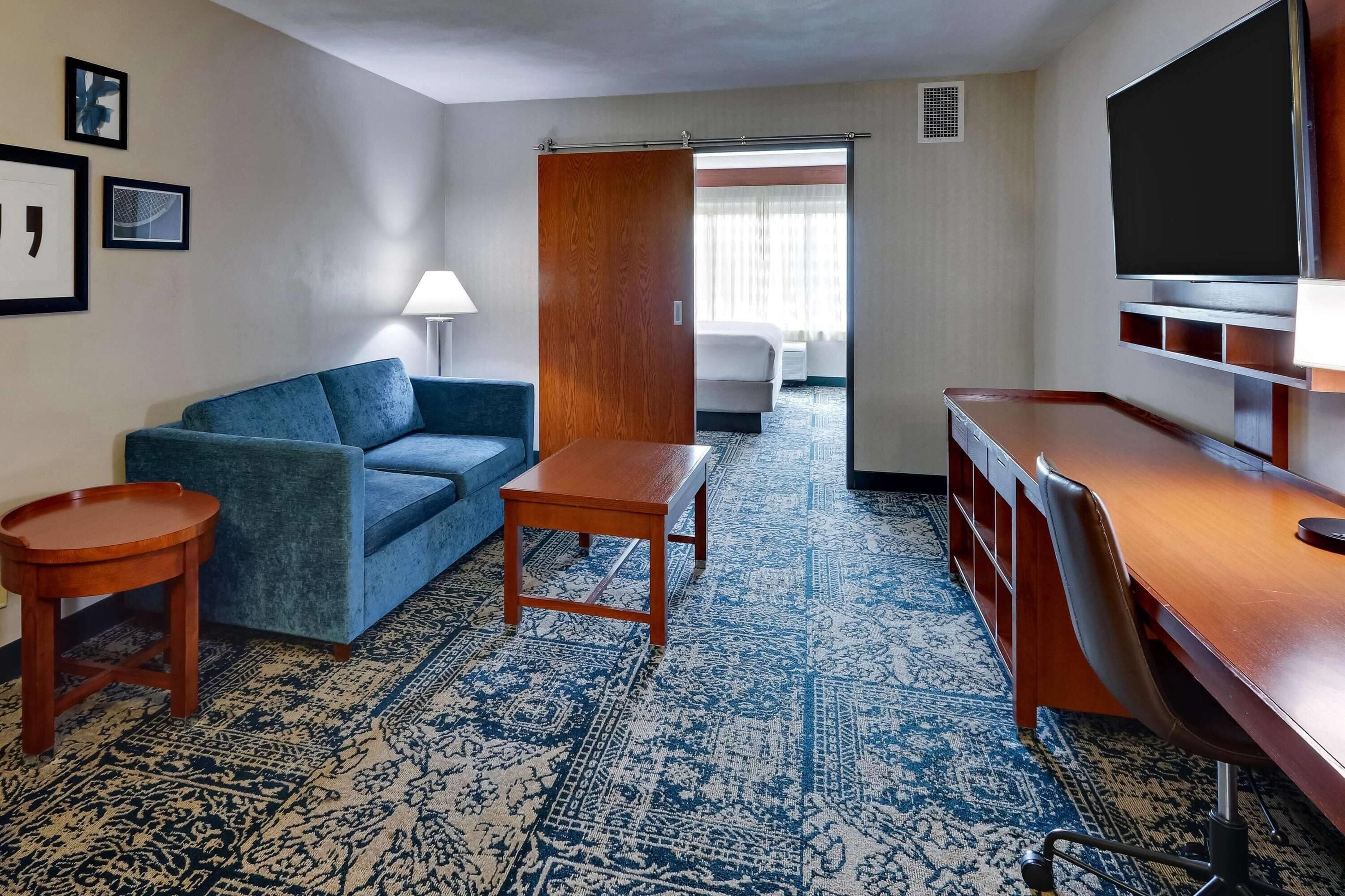 Suite, 1 King Bed, Non Smoking | Desk, laptop workspace, blackout drapes, iron/ironing board