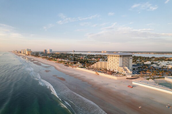 A coastal hotel with a beachfront view, multiple high-rise buildings, and a parking area. - The Shores Resort & Spa (Daytona Beach Shores)