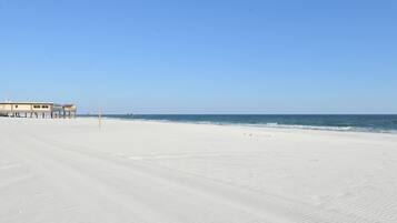 On the beach, white sand, sun loungers, beach umbrellas
