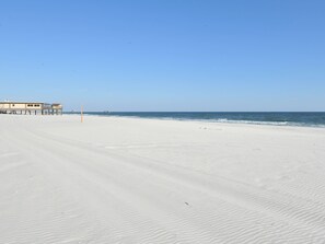 On the beach, white sand, sun-loungers, beach umbrellas