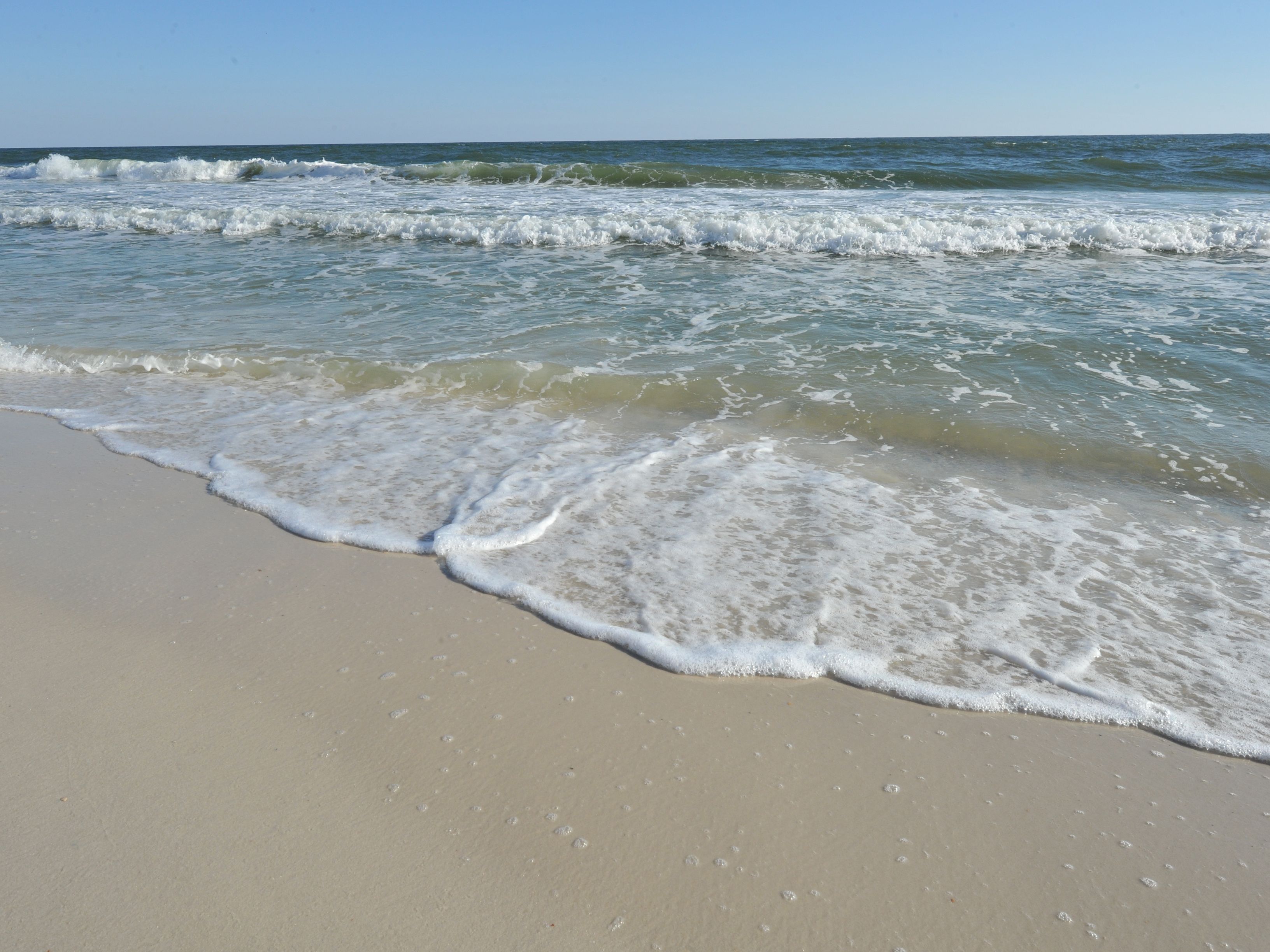 On the beach, white sand, sun loungers, beach umbrellas