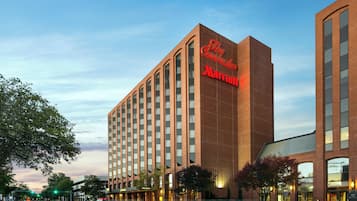 Stylish hotel building with a prominent sign, featuring modern architecture and vertical windows.