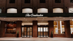 A brick building with a sign reading "The Cornhuser."