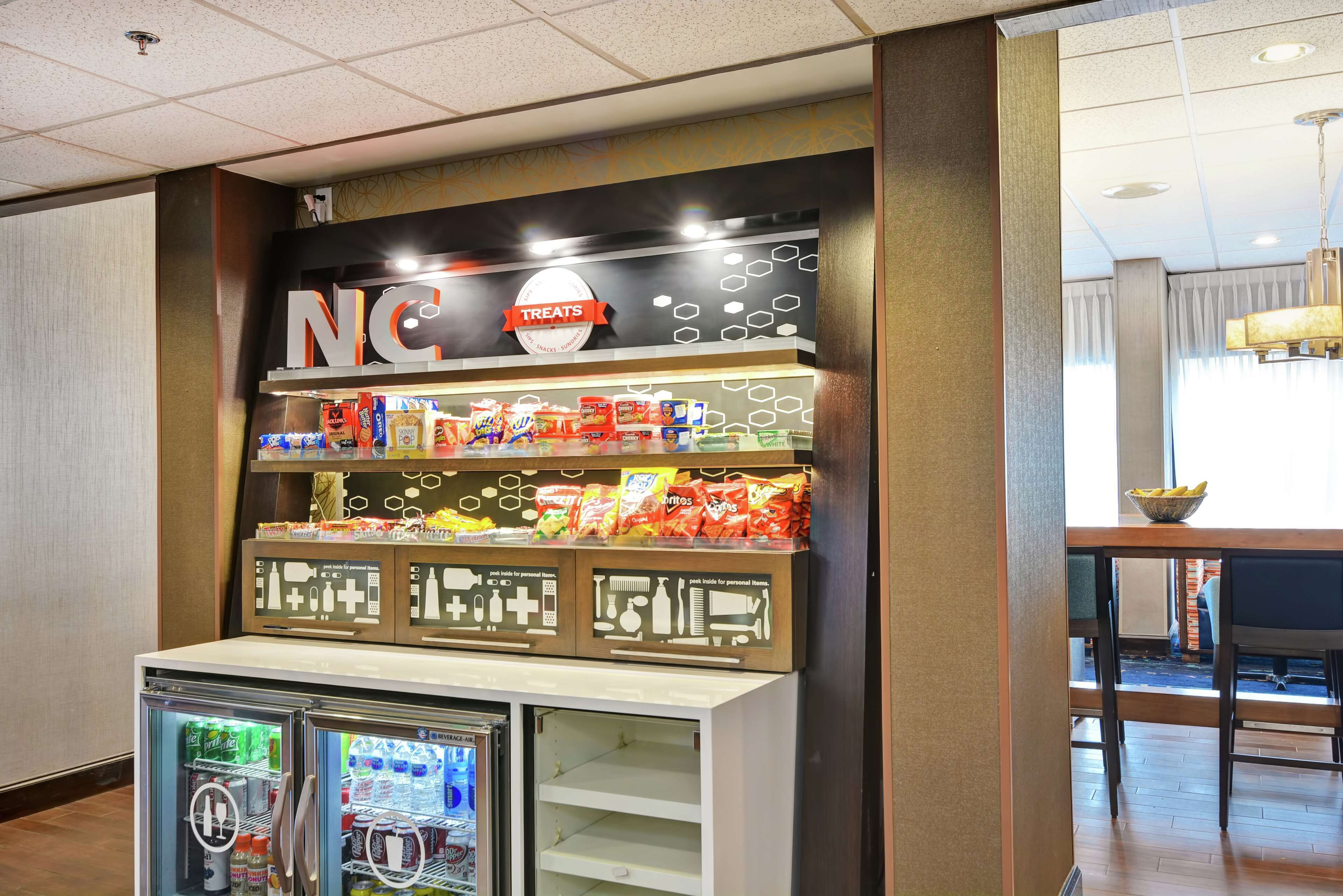 A snack bar with a refrigerated display and a variety of packaged snacks.