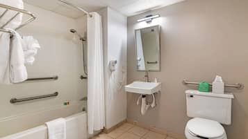 A bathroom with a bathtub, shower, toilet, and sink.