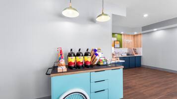 A reception area with a blue counter, a wheelchair-accessible design, and a sign that reads 'Delight in the day.'