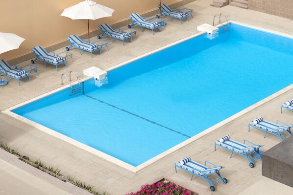Outdoor pool, open 8:00 AM to 8:00 PM, pool umbrellas, pool loungers
