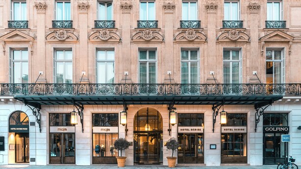 A historic building with multiple hotel entrances, including 'Hotel Scribe' and 'Hotel Scribe Paris'.