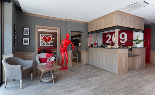 A modern interior with a bar area, a mannequin, and a seating area with a table and chairs.