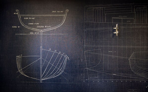 Architectural blueprints with detailed measurements and annotations, including a curved structure labeled "Riser" and "Plank."