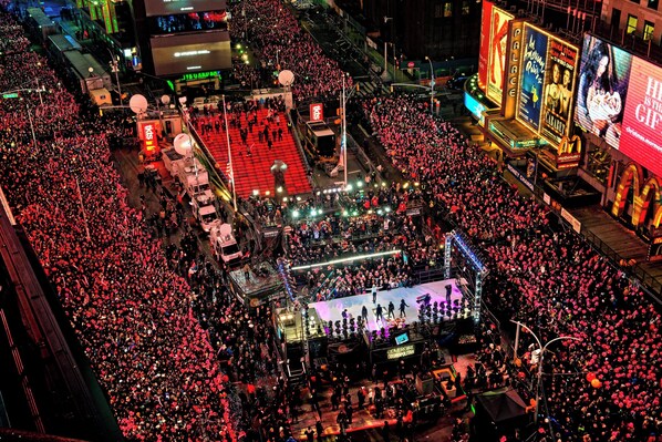 A large outdoor event with a stage and a crowd.