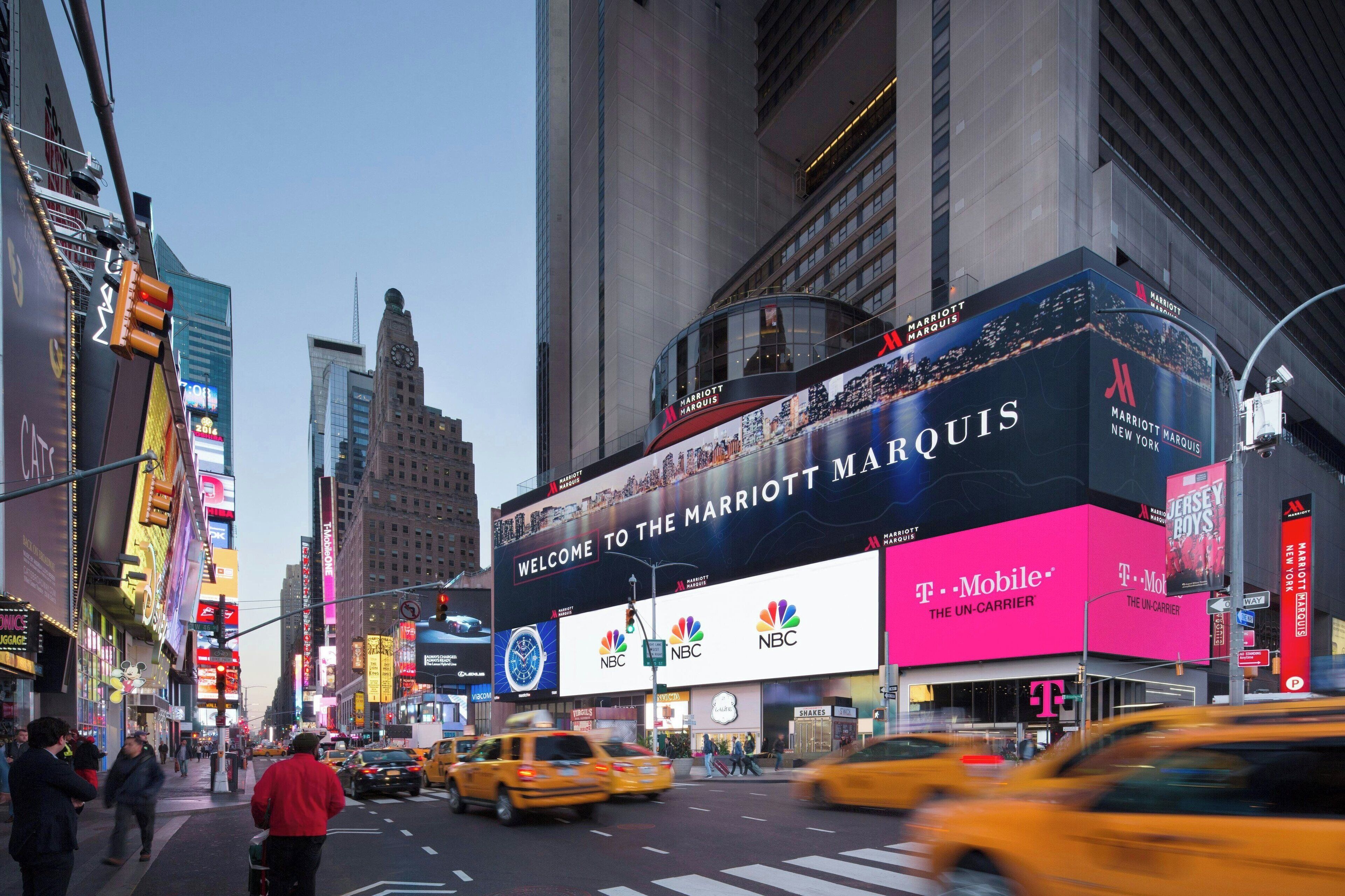 A large billboard for the Marriott Marquis hotel with NBC and T-Mobile logos.