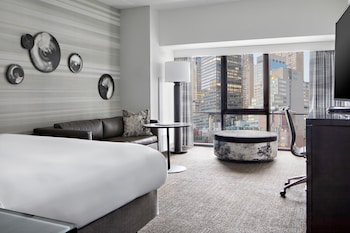 A view from a window overlooking a cityscape with tall buildings and advertisements. at New York Marriott Marquis