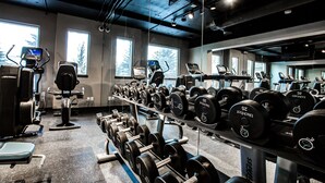 A gym with various exercise equipment, including treadmills and dumbbells. - Hotel Blackfoot (Calgary)