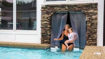 Outdoor pool, a heated pool, open 9:00 AM to 10:00 PM, pool loungers