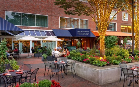 The Charles Hotel with outdoor seating and a garden area.