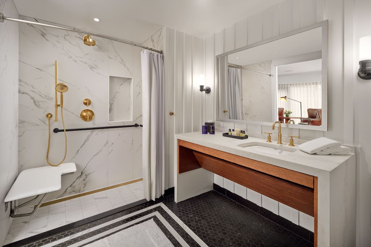 deep-soaking bathtub, designer toiletries, hair dryer, bathrobes