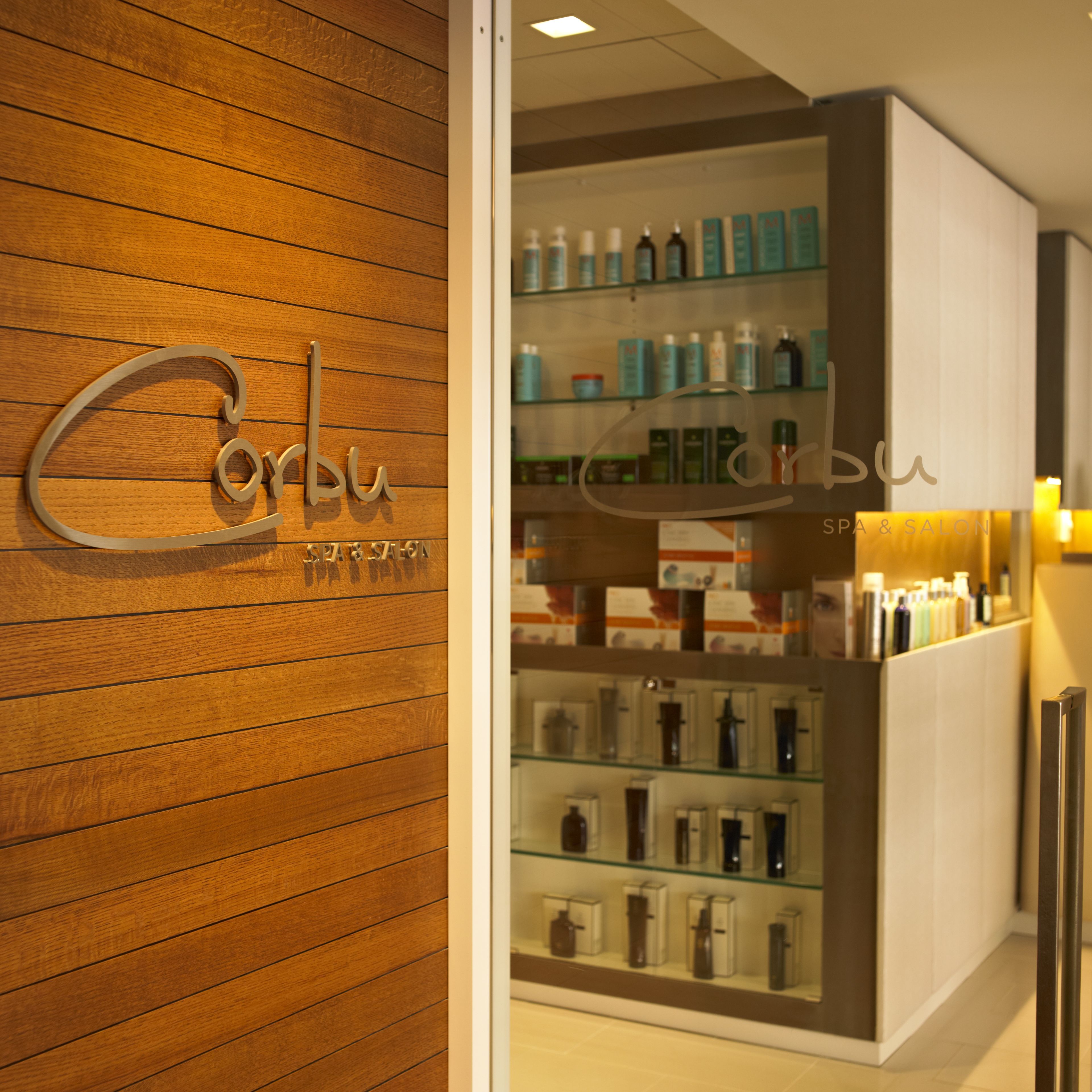 A spa and salon interior with wooden paneling and a display of various products.