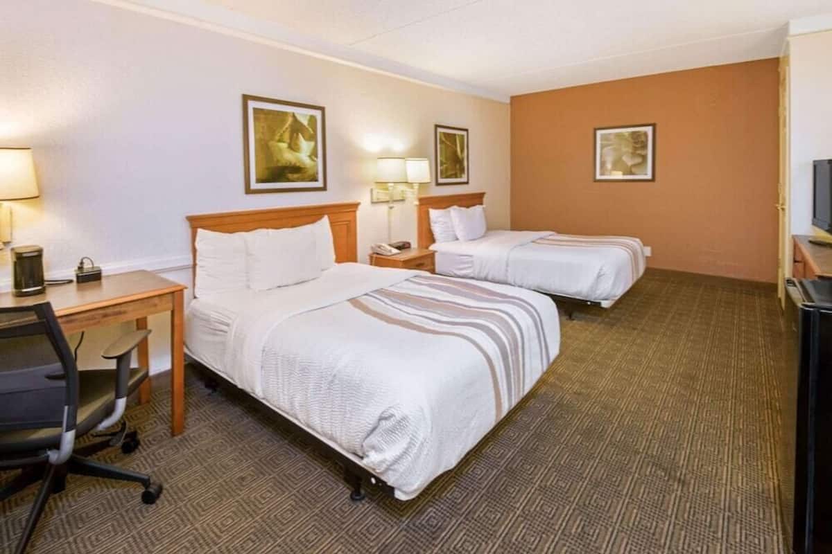 Camas con pillow-top, escritorio y cortinas blackout