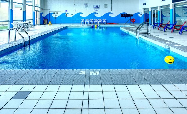 Indoor pool, open 9:00 AM to 10:00 PM, pool loungers