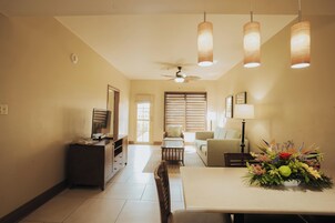 One Bedroom Deluxe 1 King | Living area | 40-inch flat-screen TV with satellite channels, TV