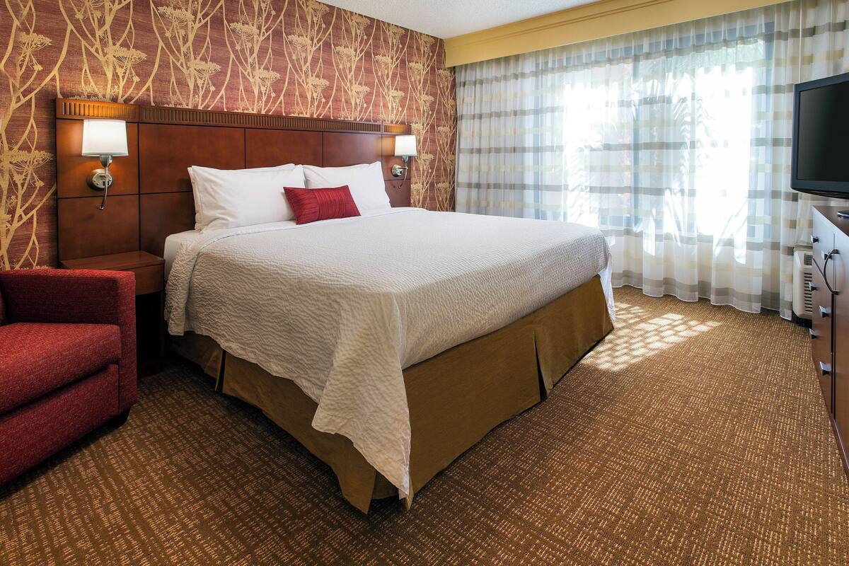 Premium bedding, desk, laptop workspace, blackout curtains