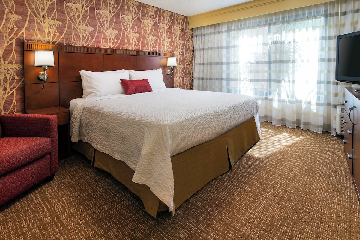 Premium bedding, desk, laptop workspace, blackout drapes