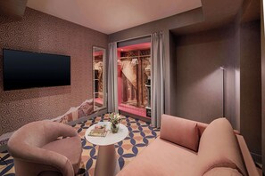 A modern hotel room with a large flat-screen TV, a sofa, a small round table with a vase of flowers, and a patterned floor. - nhow Roma Vittorio Veneto (Rome)