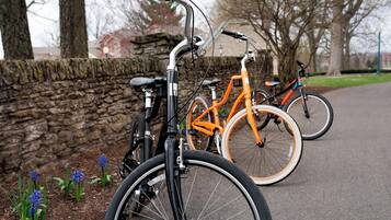 A stone wall with bicycles parked in front.