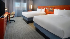 A hotel room with two beds, a desk, a chair, and a TV. - Courtyard by Marriott Columbus Worthington (Columbus)