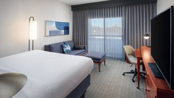 Premium bedding, desk, laptop workspace, blackout drapes