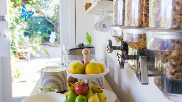 A breakfast buffet setup with various food items and utensils. - Bathurst Explorers Motel (Bathurst)