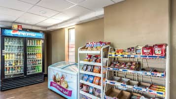 A snack and beverage vending area with a Pepsi cooler and a freezer.