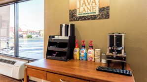 A coffee shop interior with a sign reading 'JAVA LANE' and a coffee machine.